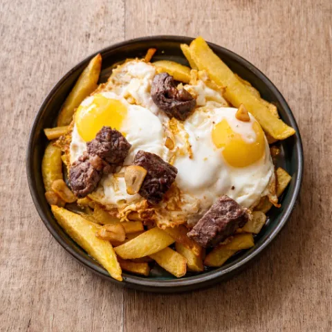 Eggs with beef tenderloin saut&eacute;ed in garlic