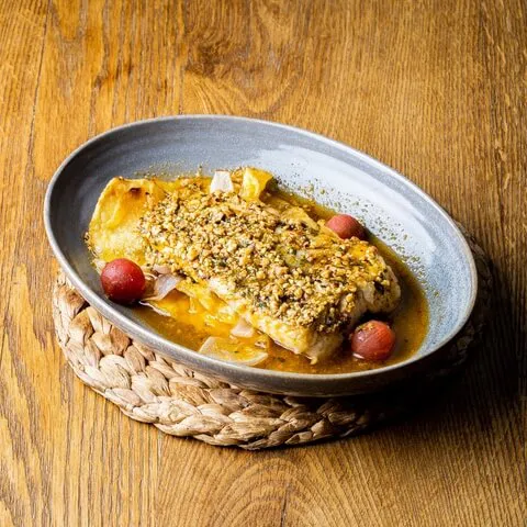 Hake baked with almonds and potato